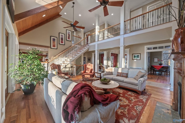 13032 Monte Vedra Rd, Huntsville, AL 35803 - living room featuring a fireplace with flush hearth, wood finished floors, visible vents, a ceiling fan, and high vaulted ceiling