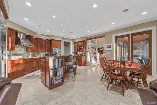 13032 Monte Vedra Rd, Huntsville, AL 35803 - kitchen featuring stainless steel oven, wall chimney range hood, decorative backsplash, and ornamental molding