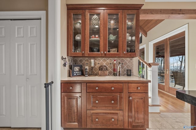 13032 Monte Vedra Rd, Huntsville, AL 35803 - bar with lofted ceiling with beams, decorative backsplash, and light tile patterned floors