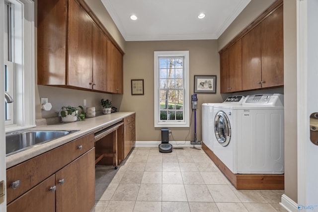 13032 Monte Vedra Rd, Huntsville, AL 35803 - laundry area with a sink, crown molding, baseboards, washer and dryer, and cabinet space