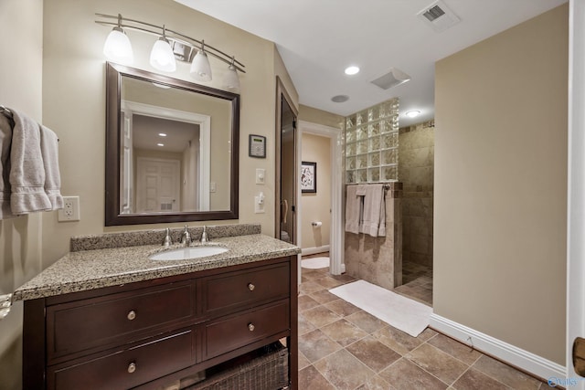13032 Monte Vedra Rd, Huntsville, AL 35803 - bathroom with visible vents, vanity, baseboards, and a walk in shower