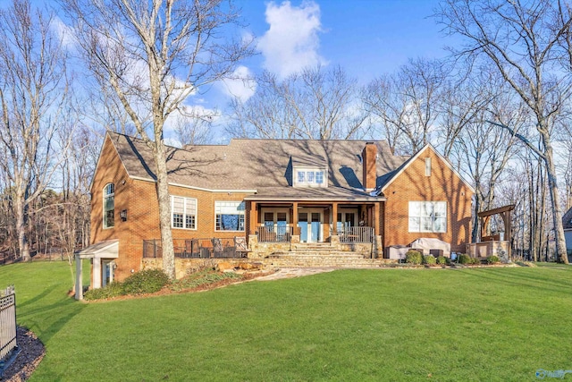 13032 Monte Vedra Rd, Huntsville, AL 35803 - rear view of house featuring brick siding, a lawn, and a porch