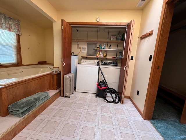 laundry room featuring radiator heating unit and washing machine and clothes dryer