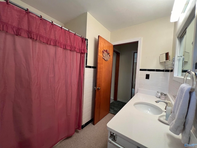 bathroom with vanity and tile walls