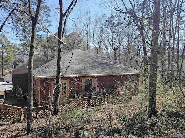 view of property exterior featuring roof with shingles