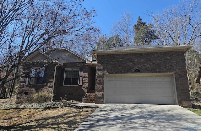 view of front facade with crawl space, a garage, concrete driveway, and brick siding