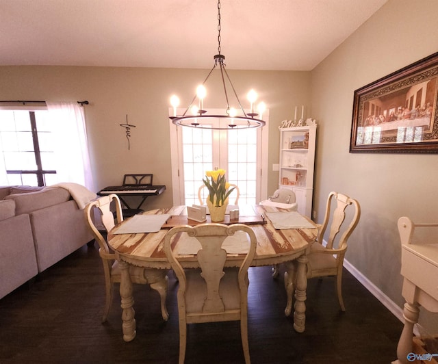 dining room with an inviting chandelier, baseboards, and dark wood finished floors