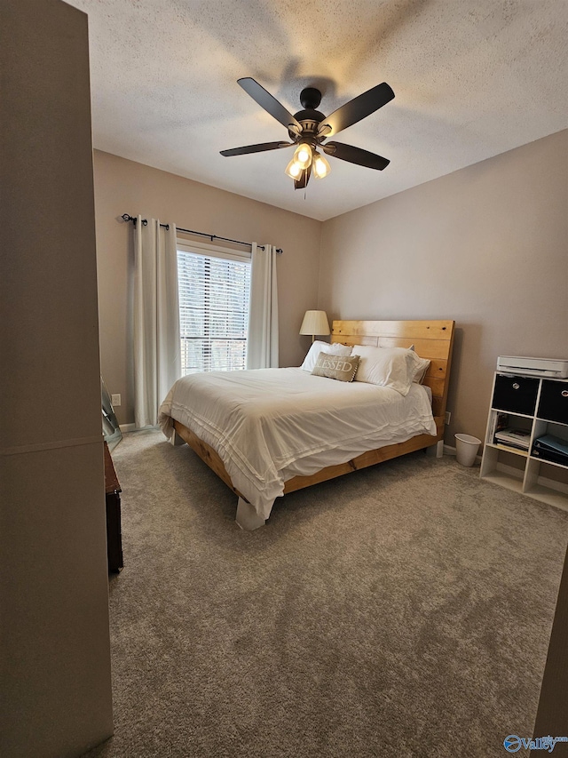 bedroom with a ceiling fan, carpet, a textured ceiling, and baseboards