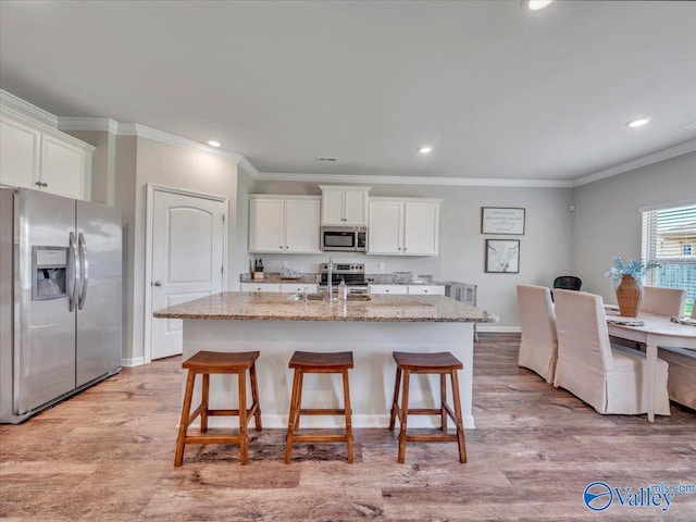 266 Dinner Tree Sq, Huntsville, AL 35811 - kitchen featuring stainless steel appliances, white cabinetry, light stone countertops, ornamental molding, and recessed lighting