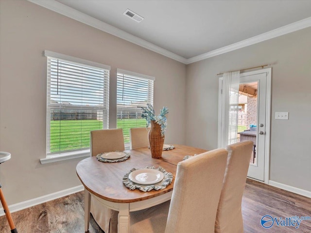 266 Dinner Tree Sq, Huntsville, AL 35811 - dining room with healthy amount of natural light, crown molding, wood finished floors, and baseboards