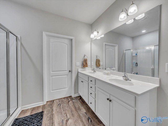 266 Dinner Tree Sq, Huntsville, AL 35811 - bathroom featuring a shower stall, wood finished floors, double vanity, and baseboards