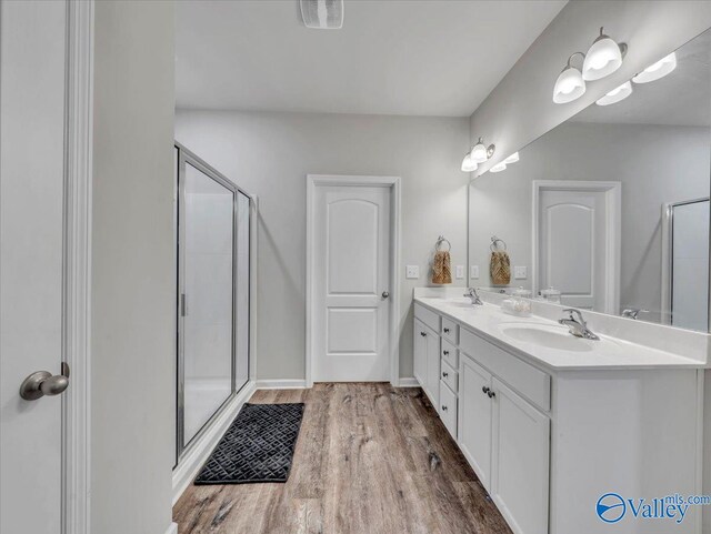 266 Dinner Tree Sq, Huntsville, AL 35811 - bathroom with a shower stall, wood finished floors, and double vanity