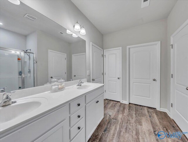266 Dinner Tree Sq, Huntsville, AL 35811 - bathroom with a shower stall, wood finished floors, and double vanity