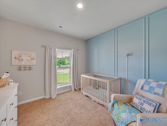 266 Dinner Tree Sq, Huntsville, AL 35811 - bedroom featuring light colored carpet, baseboards, and a nursery area