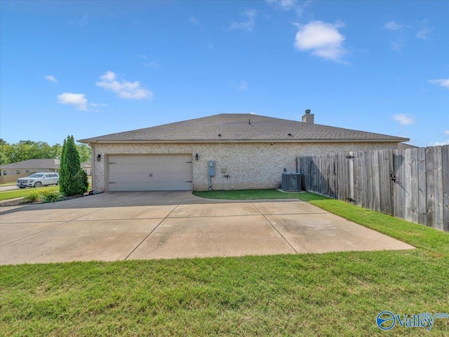 266 Dinner Tree Sq, Huntsville, AL 35811 - view of side of property with central AC, an attached garage, concrete driveway, and a chimney