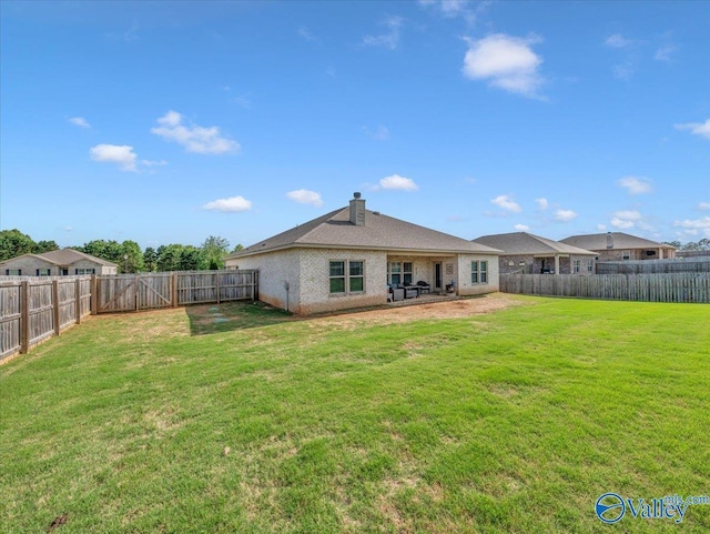 266 Dinner Tree Sq, Huntsville, AL 35811 - rear view of house with a chimney and brick siding