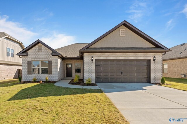 view of front of property featuring a garage and a front lawn