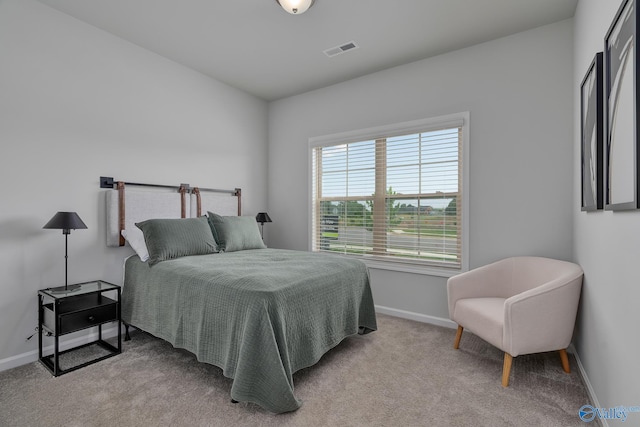 bedroom featuring light carpet