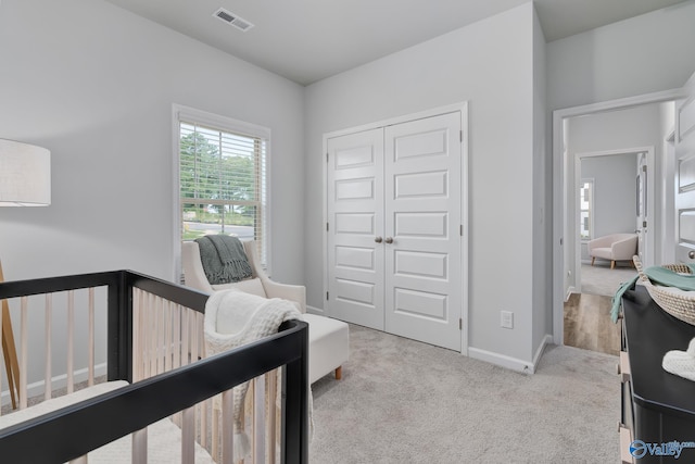 carpeted bedroom featuring a closet