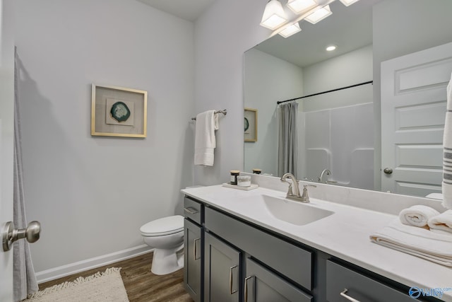 bathroom featuring hardwood / wood-style flooring, vanity, a shower with curtain, and toilet