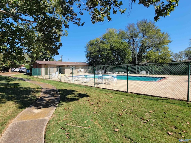 view of swimming pool with a lawn and a patio area