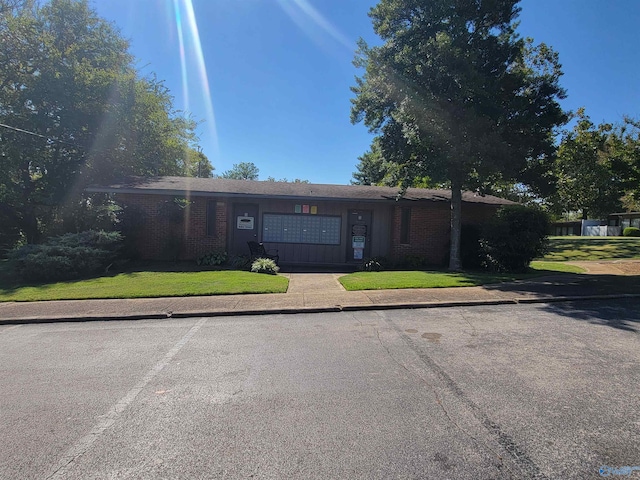 ranch-style house with a front lawn