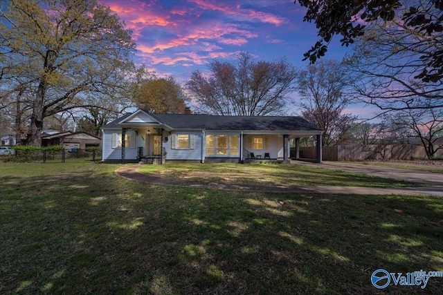 1228 W Market St, Athens, AL 35611 - view of front of house featuring driveway, a carport, fence, and a yard