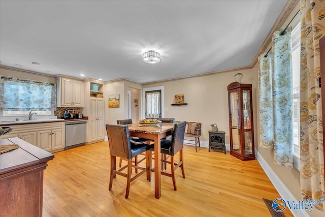 1228 W Market St, Athens, AL 35611 - dining area with baseboards, light wood-type flooring, and crown molding