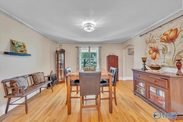 1228 W Market St, Athens, AL 35611 - dining area featuring arched walkways, light wood-type flooring, and crown molding