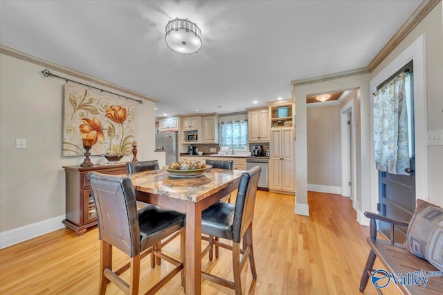 1228 W Market St, Athens, AL 35611 - dining area featuring baseboards, ornamental molding, and light wood finished floors