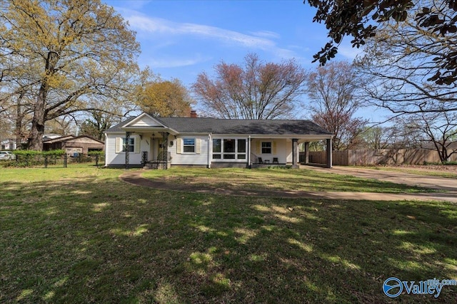 1228 W Market St, Athens, AL 35611 - view of front of home featuring fence, dirt driveway, a chimney, a front yard, and a carport