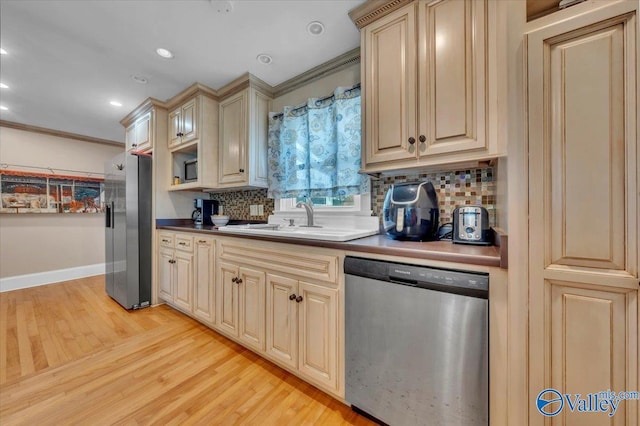 1228 W Market St, Athens, AL 35611 - kitchen with a sink, appliances with stainless steel finishes, light wood-style floors, and decorative backsplash