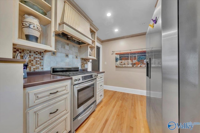 1228 W Market St, Athens, AL 35611 - kitchen with cream cabinets, stainless steel appliances, open shelves, and decorative backsplash