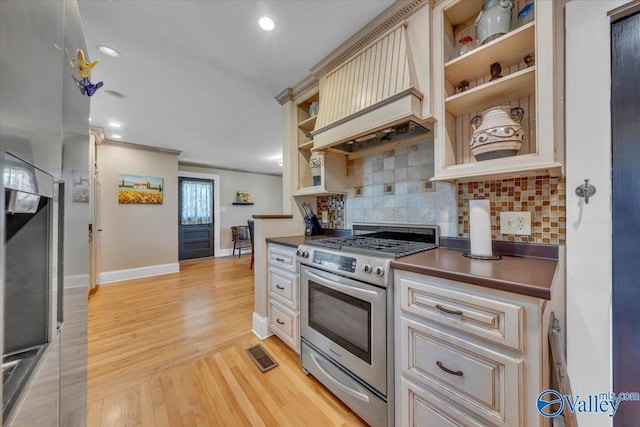 1228 W Market St, Athens, AL 35611 - kitchen featuring open shelves, tasteful backsplash, gas stove, dark countertops, and cream cabinetry