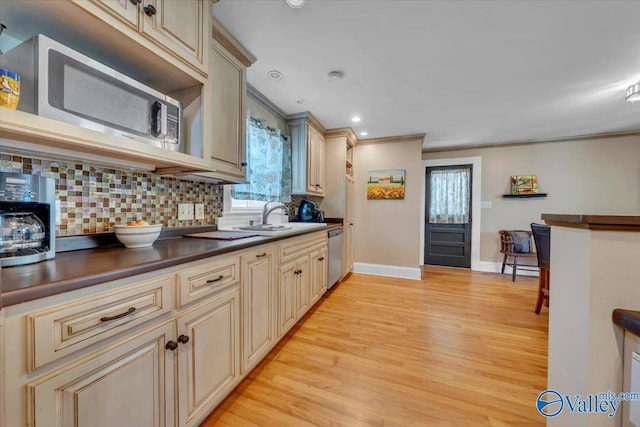 1228 W Market St, Athens, AL 35611 - kitchen with cream cabinets, a sink, dark countertops, and stainless steel appliances