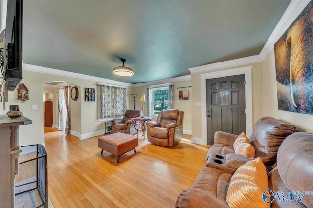 1228 W Market St, Athens, AL 35611 - living room featuring ornamental molding, arched walkways, baseboards, and light wood-type flooring