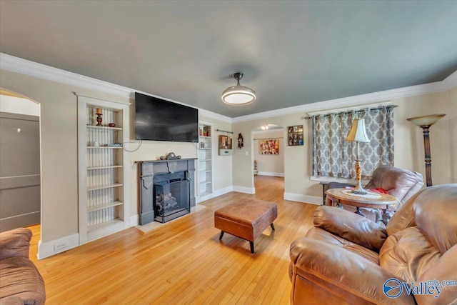 1228 W Market St, Athens, AL 35611 - living area featuring arched walkways, a fireplace with flush hearth, wood finished floors, and crown molding