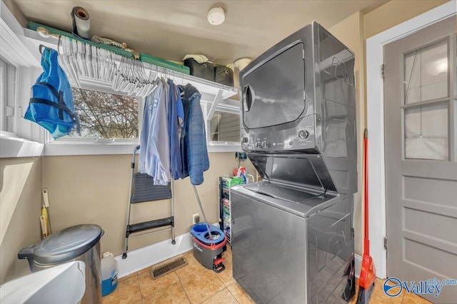 1228 W Market St, Athens, AL 35611 - washroom featuring visible vents, stacked washer / dryer, baseboards, laundry area, and tile patterned floors