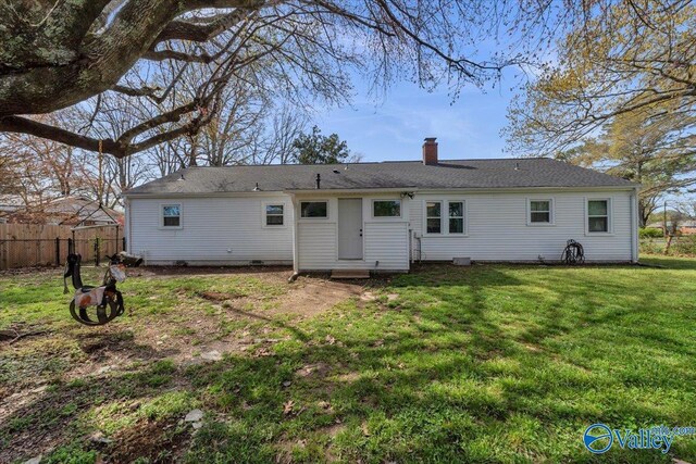 1228 W Market St, Athens, AL 35611 - back of house featuring a chimney, fence, and a yard