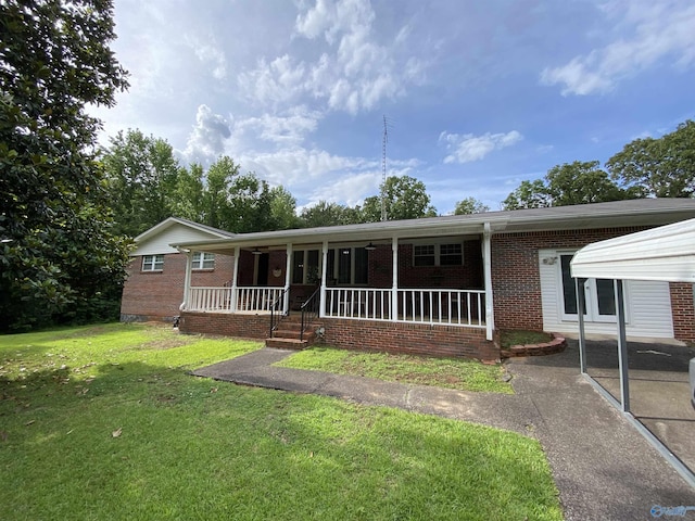 135 Forest Hill Rd, Trinity, AL 35673 - ranch-style house featuring brick siding, a front yard, and covered porch