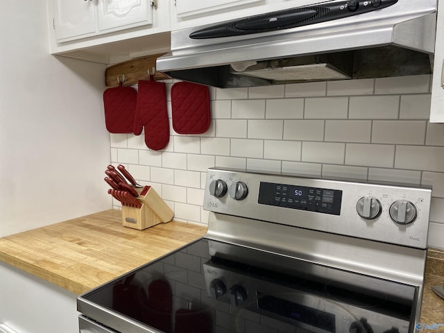 135 Forest Hill Rd, Trinity, AL 35673 - kitchen featuring electric stove, exhaust hood, tasteful backsplash, and white cabinetry