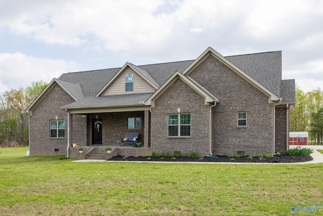 15153 Hobbs Rd, Athens, AL 35614 - view of front of house featuring roof with shingles, covered porch, a front yard, and brick siding