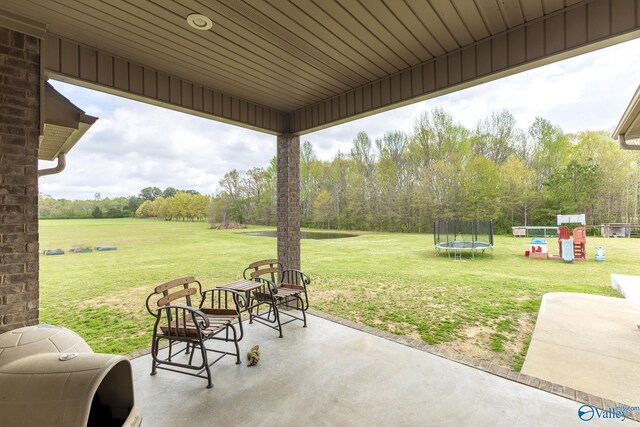 15153 Hobbs Rd, Athens, AL 35614 - view of patio featuring a trampoline and a playground