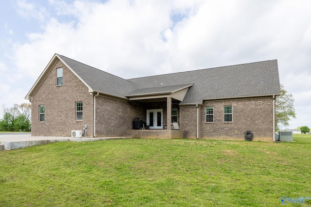 15153 Hobbs Rd, Athens, AL 35614 - back of property featuring roof with shingles, a yard, brick siding, and french doors