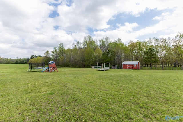 15153 Hobbs Rd, Athens, AL 35614 - view of yard featuring a storage shed, a trampoline, a playground, and an outdoor structure