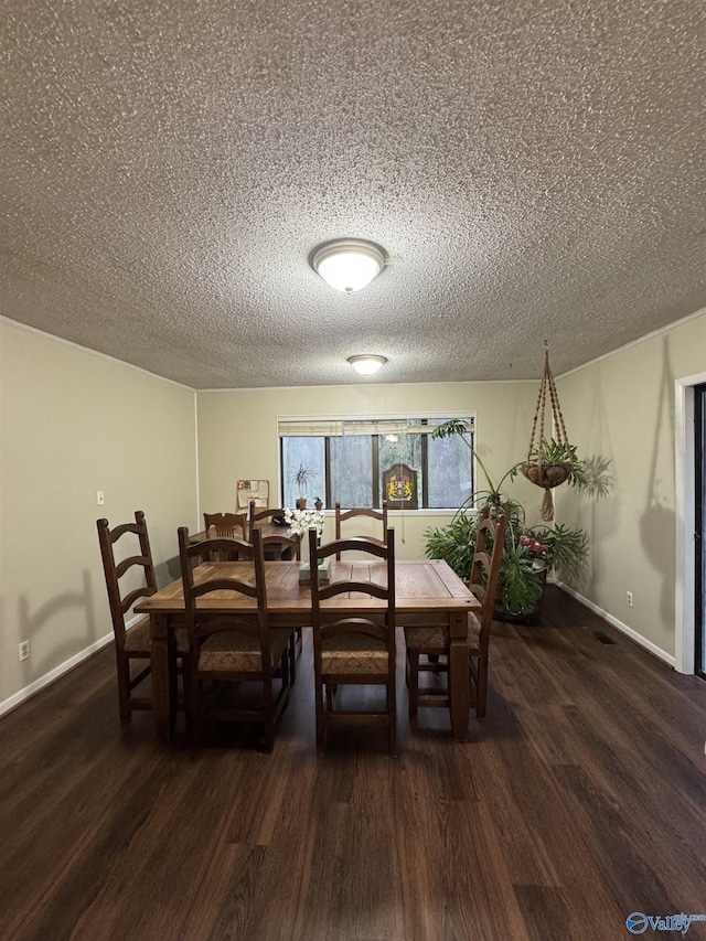 dining area featuring baseboards, wood finished floors, and a textured ceiling