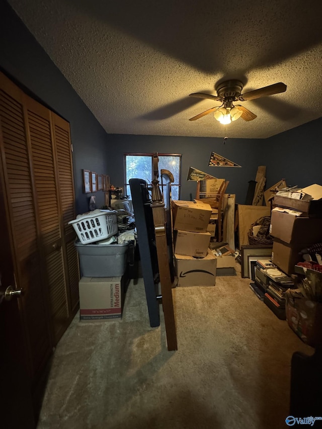 bedroom featuring a ceiling fan, carpet floors, a closet, and a textured ceiling