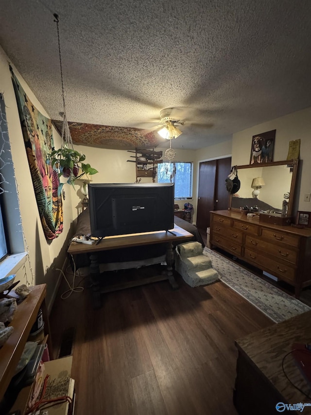 interior space featuring a textured ceiling, wood finished floors, and a ceiling fan