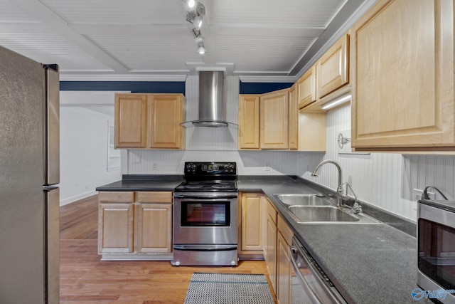 kitchen with appliances with stainless steel finishes, wall chimney exhaust hood, light brown cabinets, light hardwood / wood-style floors, and sink