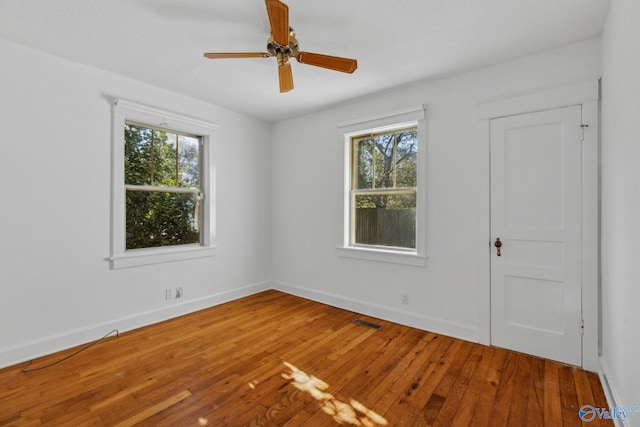 unfurnished room with ceiling fan and hardwood / wood-style flooring